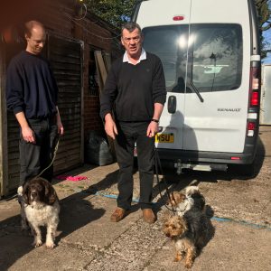 Simon and Gareth, the dog whisperer hold dogs on leads