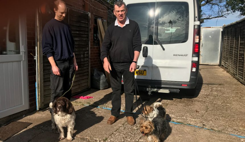 Simon and Gareth, the dog whisperer hold dogs on leads