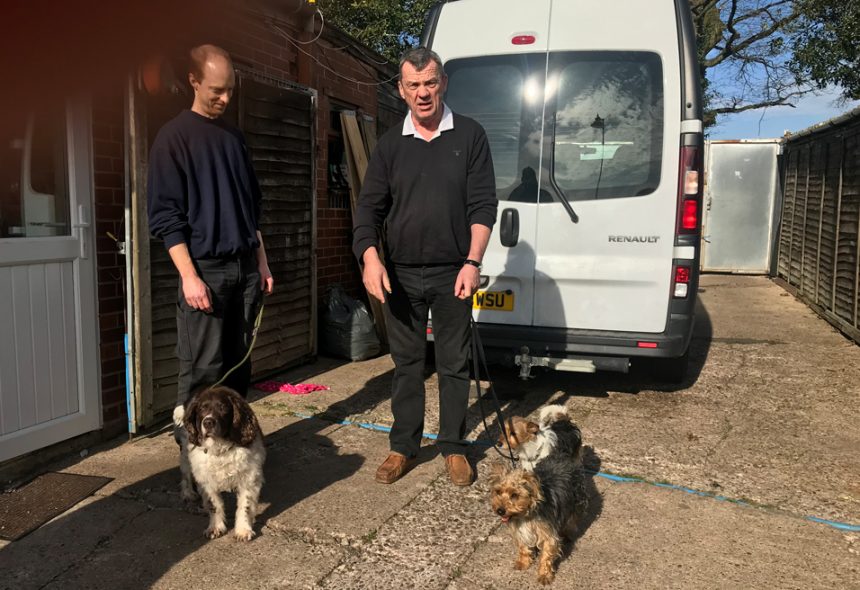 Simon and Gareth, the dog whisperer hold dogs on leads