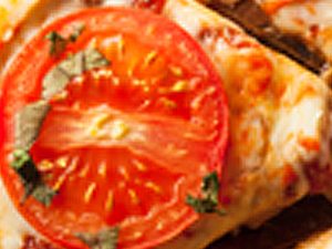 margherita pizza with tomato and herbs on top