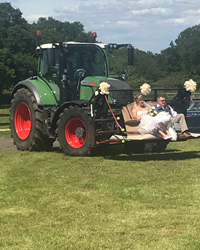 tractor carrying bride and groom