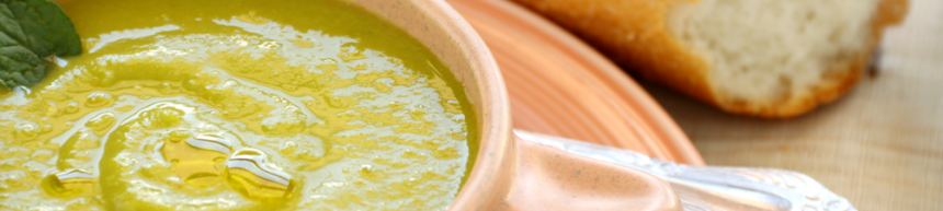 pea soup in a bowl with crusty bread roll