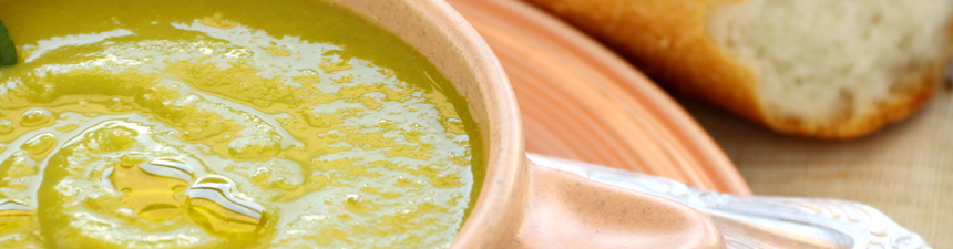 pea soup in a bowl with crusty bread roll