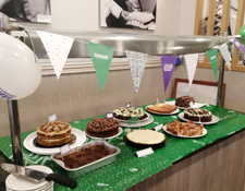 cakes on table on green cloth for macmillan cancer support